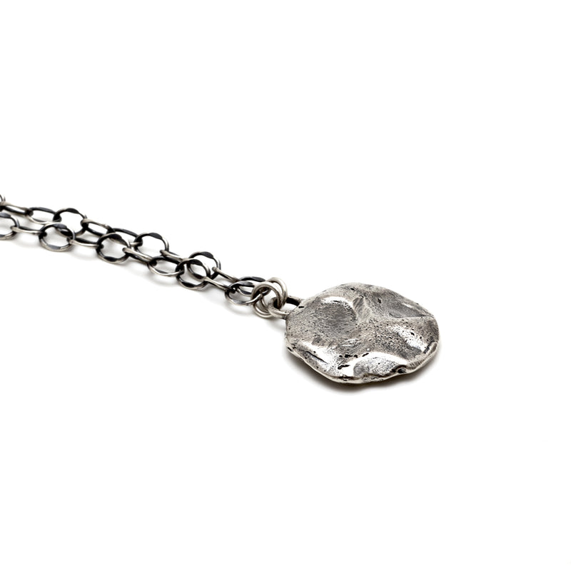 A closeup of the Restituo Medallion Necklace in Recycled Sterling Silver by Bexon Jewelry