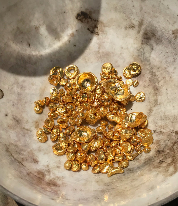 A close-up image of pure refined 24k yellow gold flakes Bexon Jewelry Blog