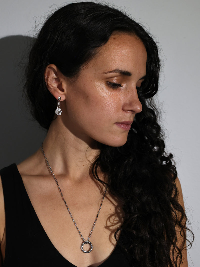 A model wears the Motus necklace in recycled sterling silver by Bexon Jewelry